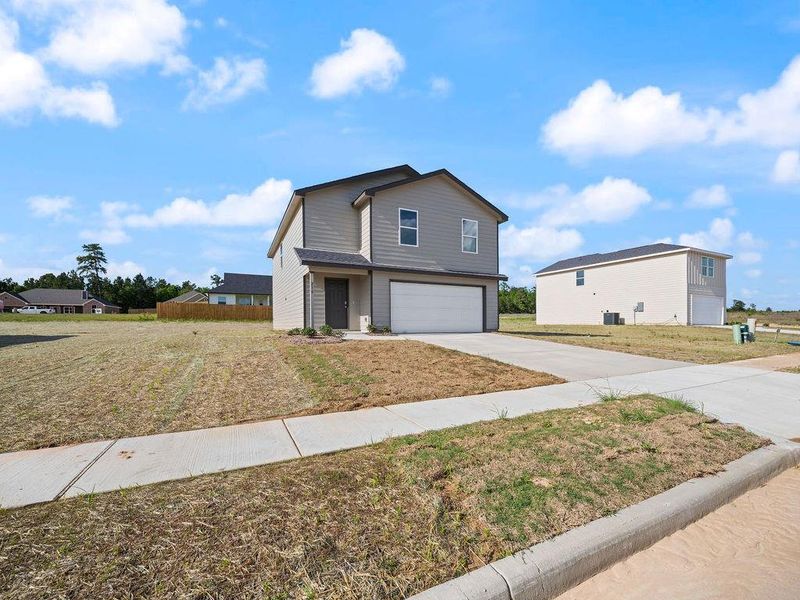 Front exterior of a new home in Stoney Ridge, Hudson, TX, highlighting curb appeal (Image 16).
