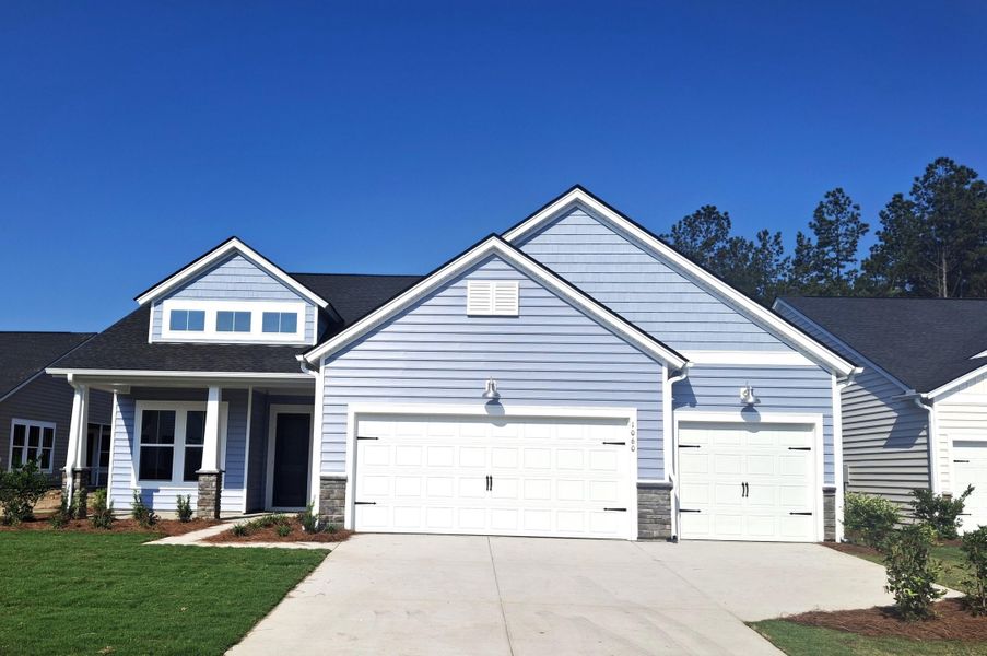 Front exterior of a new home in Horizons at Summers Corner | 55+, Summerville, SC, highlighting curb appeal (Image 1). Front exterior of a new home in Horizons at Summers Corner | 55+, Summerville, SC, highlighting curb appeal (Image 1).