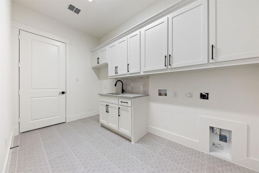 You'll be doing laundry in style in this over the top laundry room!