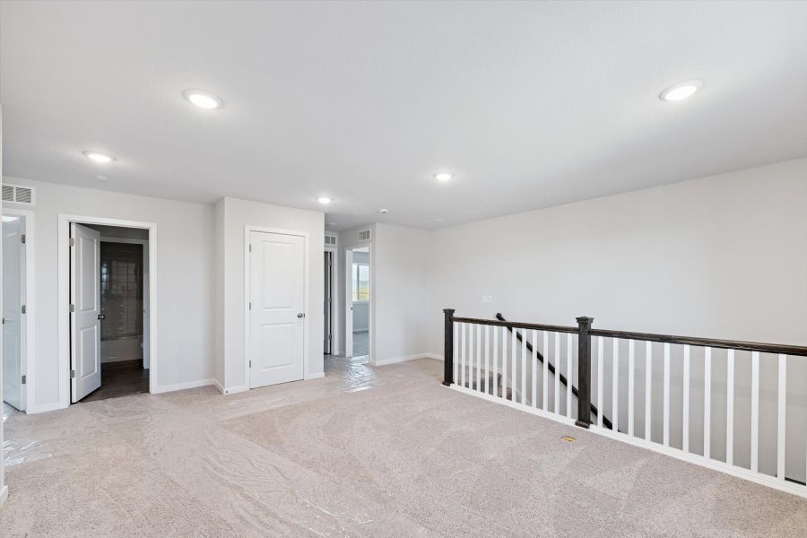 A hallway with white doors.