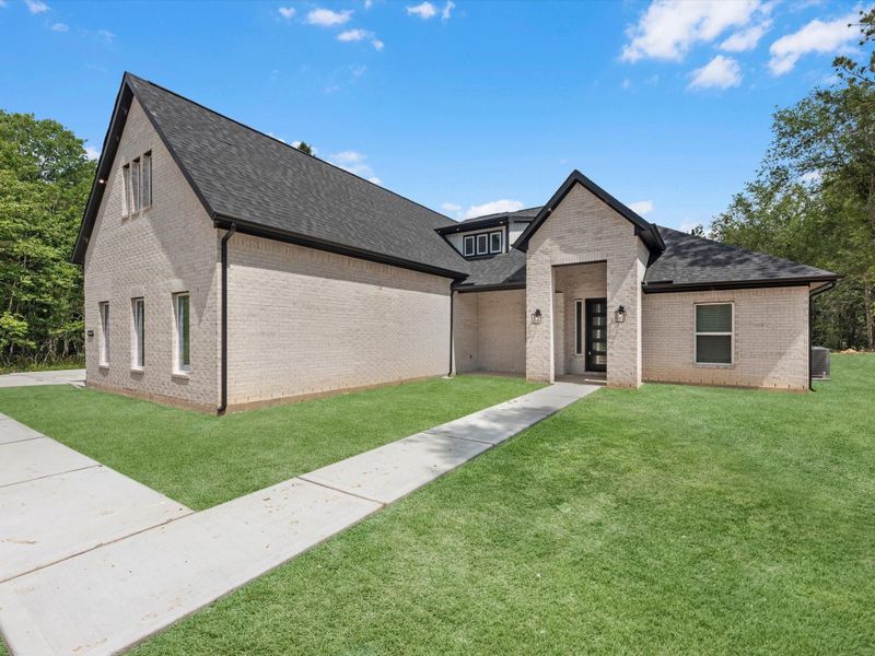 Front exterior of a new home in , Dayton, TX, highlighting curb appeal (Image 24).