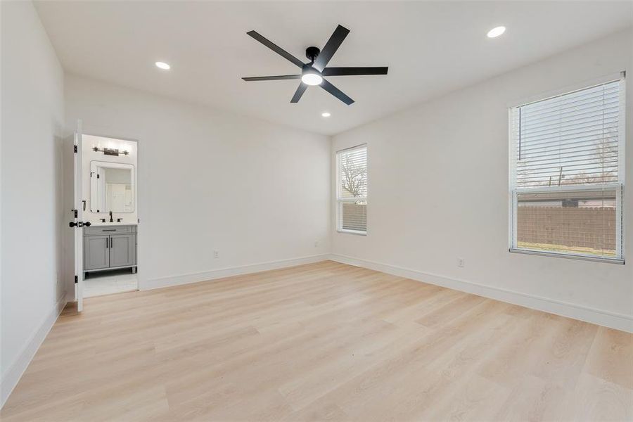 Spare room with light hardwood / wood-style floors, ceiling fan, and sink