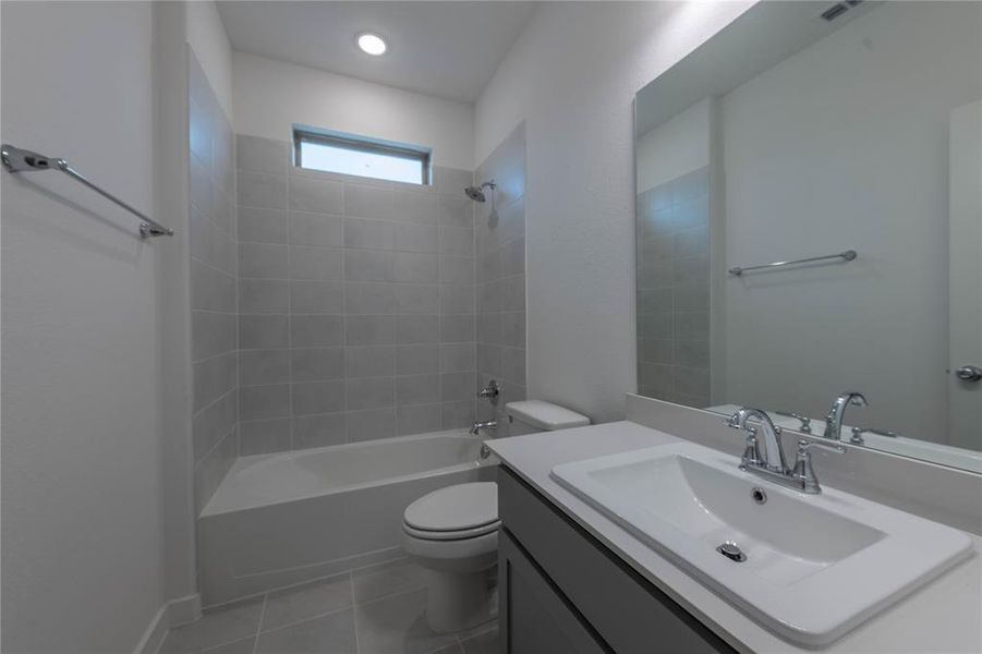 Kitchen with a sink, appliances with stainless steel finishes, gray cabinetry, decorative backsplash, and recessed lighting