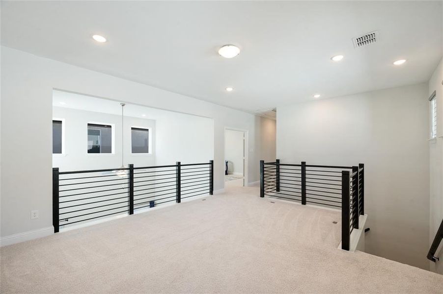 Stunning horizontal iron banister surrounds upstairs living space.