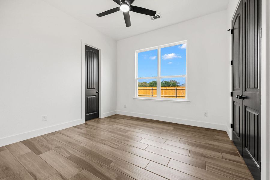 Spare room featuring light wood-style floors and a ceiling fan