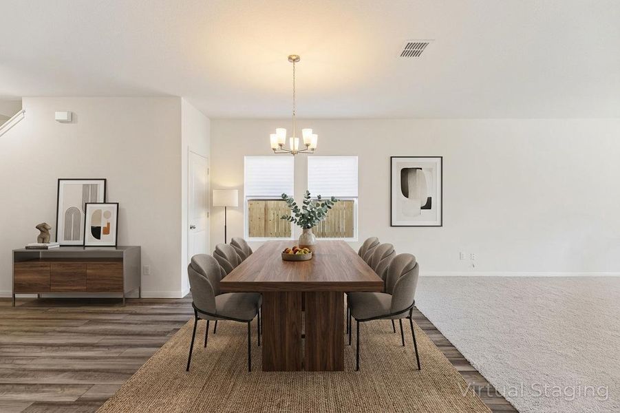 Dining space with suspended lighting and dark wood-style flooring