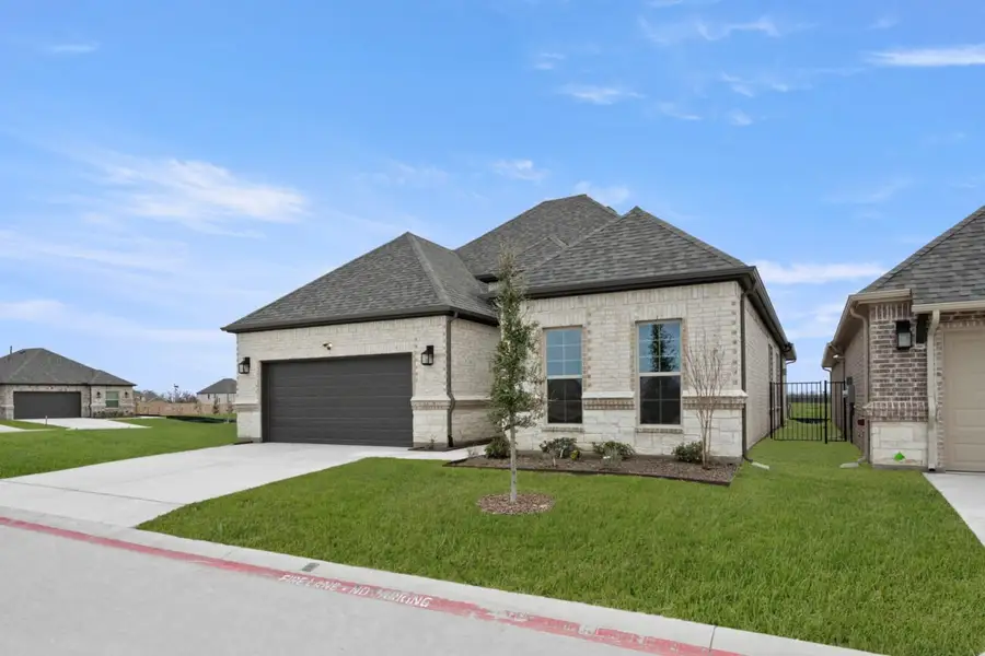 Front exterior of a new home in Ladera at Timberbrook, Justin, TX, highlighting curb appeal (Image 2). Front exterior of a new home in Ladera at Timberbrook, Justin, TX, highlighting curb appeal (Image 2).