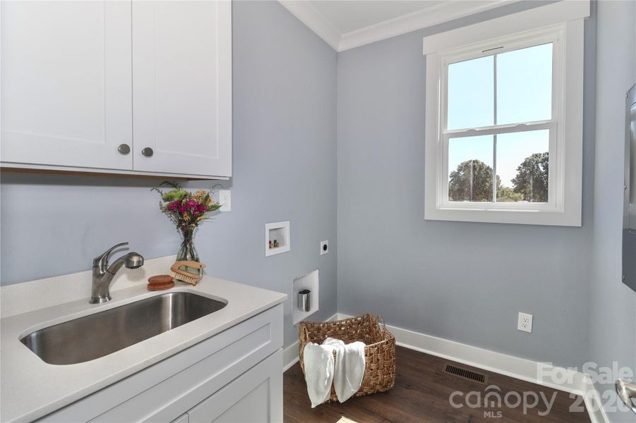 The conveniently placed laundry room offers practicality and ease, streamlining household chores. The conveniently placed laundry room offers practicality and ease, streamlining household chores.