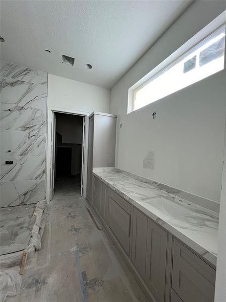 Partial master bath showing spacious vanities with plenty of storage and large walk in mater shower.