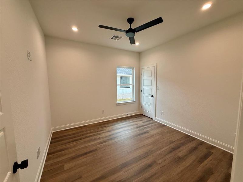 Spare room featuring a ceiling fan, dark wood-style flooring, and recessed lighting
