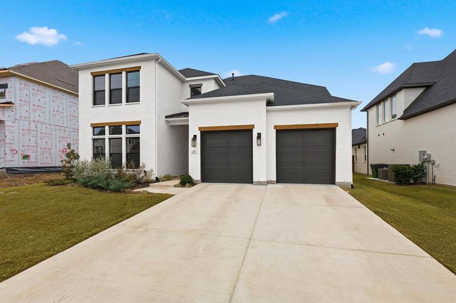 Front exterior of a new home in Windsong Ranch 61' Series, Prosper, TX, highlighting curb appeal (Image 24).