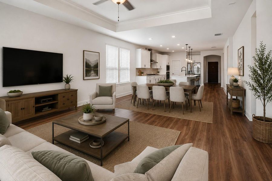Virtually Staged PhotoAn open-concept interior boasts rich wood flooring and a modern kitchen flowing into a dining area.