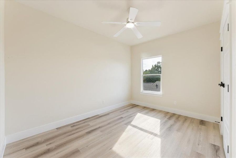 Unfurnished room with light wood-style floors and ceiling fan