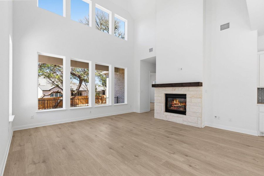 Family Room with soaring ceiling & fireplace