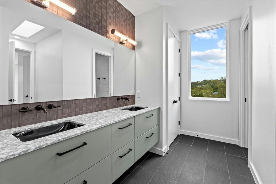 Bathroom 4  - double sinks - counters are Palladio Griso Marble by Santamargherita. Flooring is 12x24 Wide Steel Struttura. Tile is 3x12 Meringue ll white Matte and 12x12 Celavio E Black