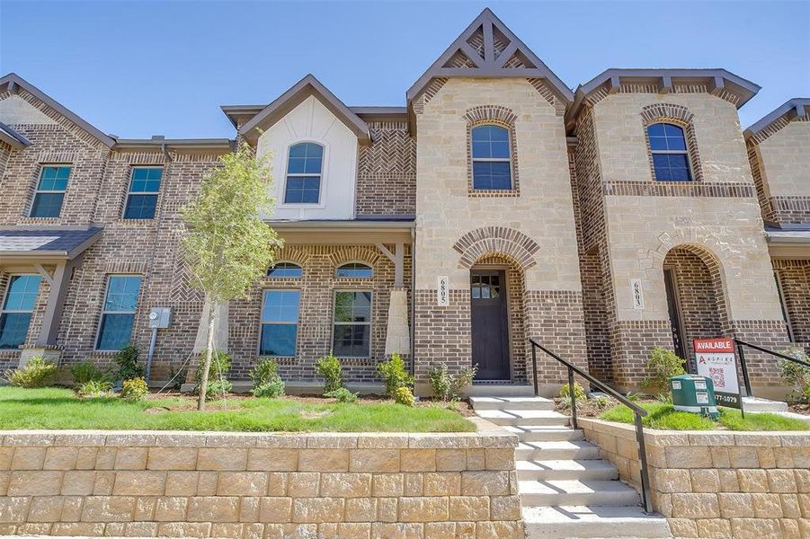 French provincial home featuring brick siding French provincial home featuring brick siding