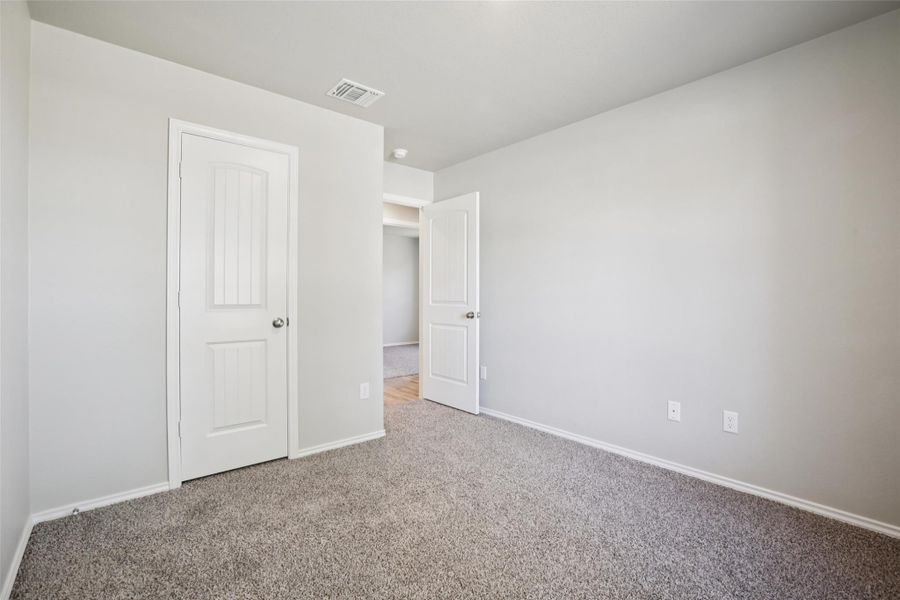 Unfurnished bedroom featuring carpet and baseboards