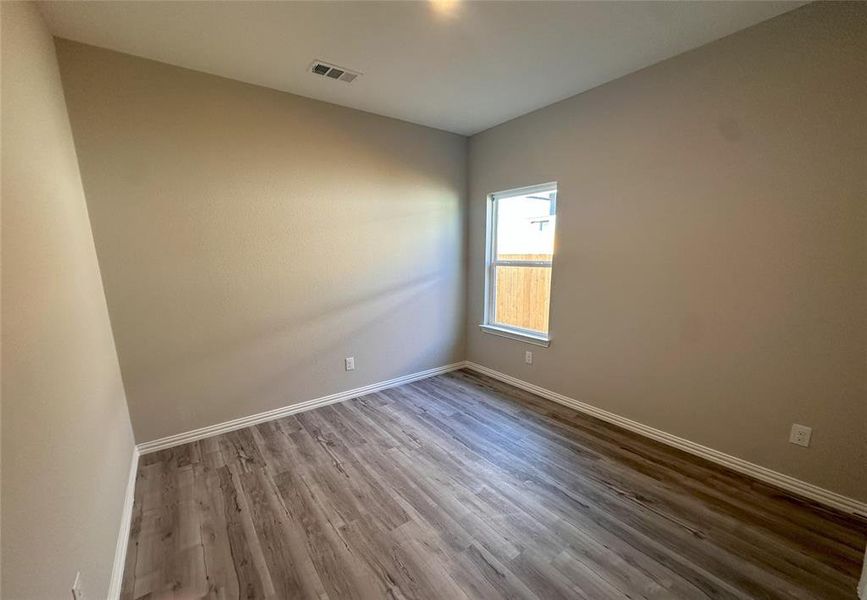 Spare room featuring wood-type flooring