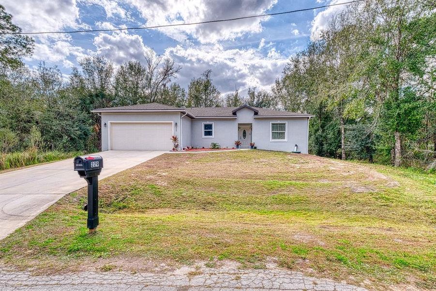 Front exterior of a new home in , Poinciana, FL, highlighting curb appeal (Image 21).