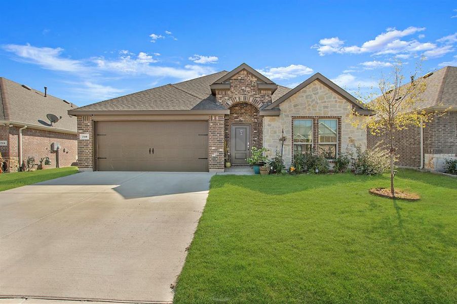 View of front of house with a front lawn and a garage