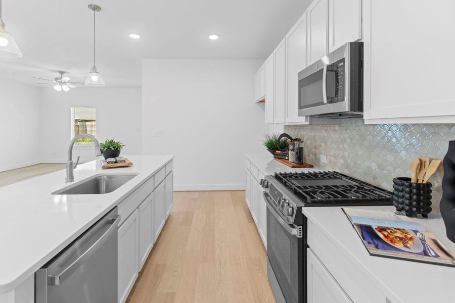 Every detail in this kitchen was made to impress, from the tile backsplash to the five-burner gas range and modern finishes that blend beauty with function. The beautiful kitchen pulls out swan faucet! Shiny sparkling quartz countertops will surround you!