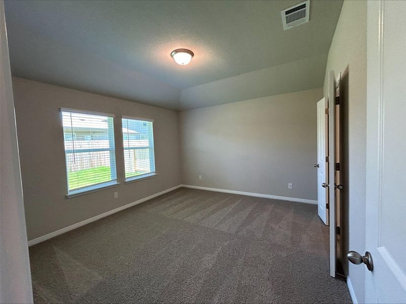 Unfurnished room with carpet and lofted ceiling Unfurnished room with carpet and lofted ceiling
