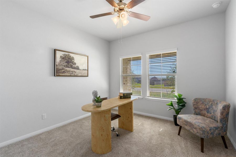 Office featuring light colored carpet and ceiling fan
