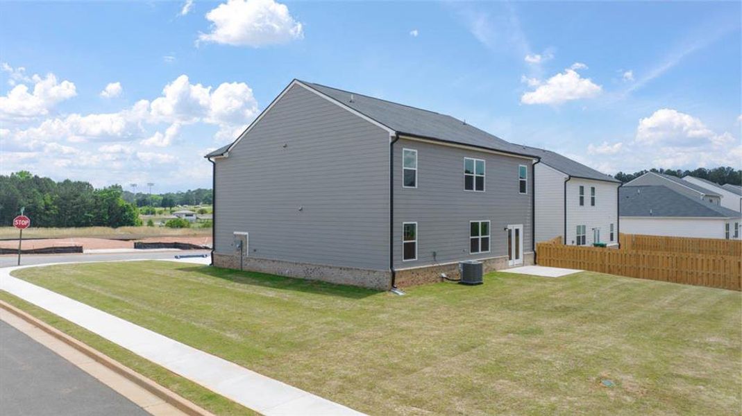 Front exterior of a new home in The Reserve at Calcutta, Stockbridge, GA, highlighting curb appeal (Image 24).