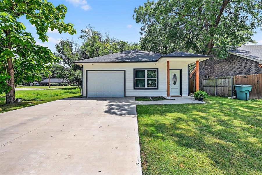 View of front facade featuring concrete driveway, a garage, and roof with shingles View of front facade featuring concrete driveway, a garage, and roof with shingles