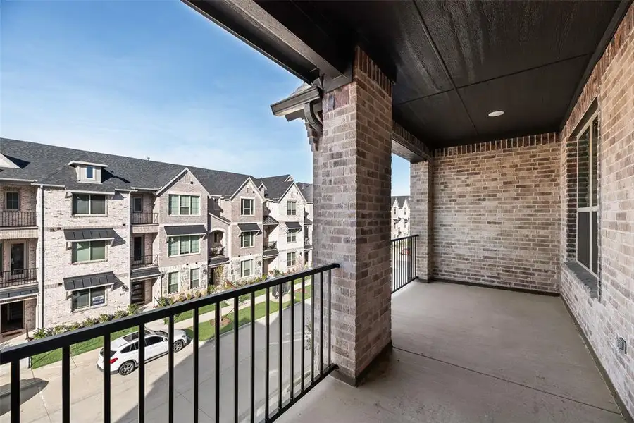 Exterior details and patio area of a home in Wade Settlement Townhomes, Frisco (Image 4).