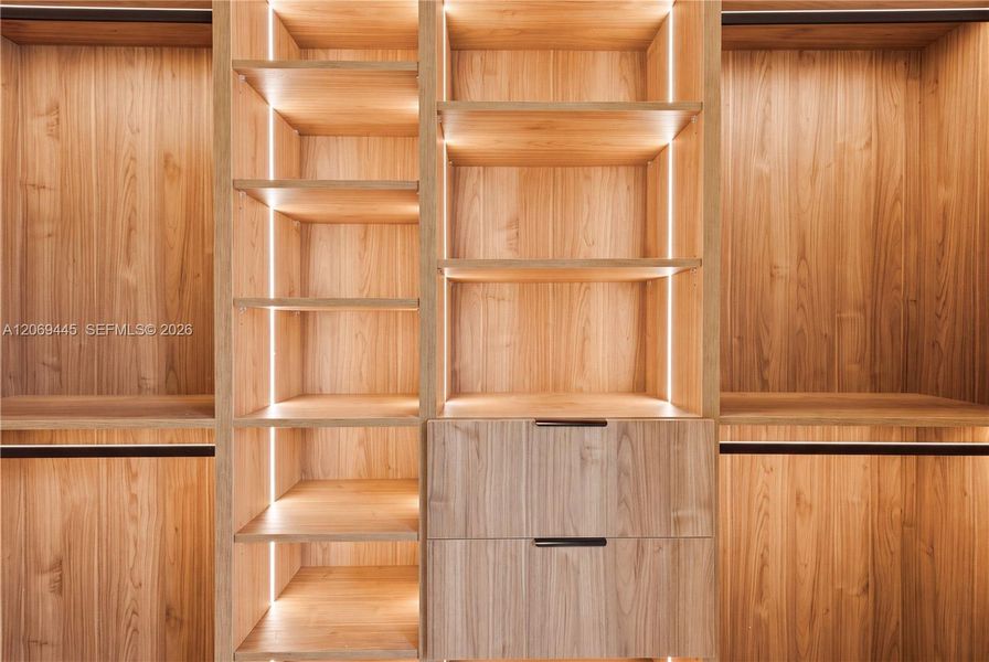 Integrated LED lighting and built-in drawers elevate the closets with a luxurious boutique-style feel. Integrated LED lighting and built-in drawers elevate the closets with a luxurious boutique-style feel.