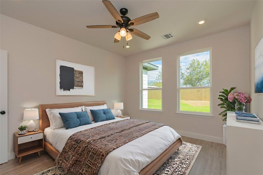 Bedroom featuring light hardwood / wood-style flooring and ceiling fan