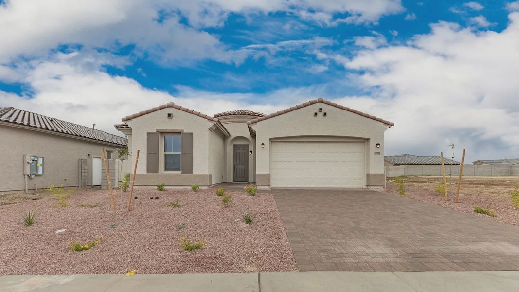 Front exterior of a new home in Arroyo Seco - Hacienda, Buckeye, AZ, highlighting curb appeal (Image 1). Front exterior of a new home in Arroyo Seco - Hacienda, Buckeye, AZ, highlighting curb appeal (Image 1).