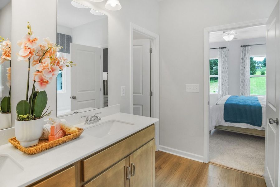 Primary owner's bath.  This picture is from our furnished and decorated model home in the community.  Window placement and color scheme may vary per unit location.  Ask agent for more specific details regarding color and options