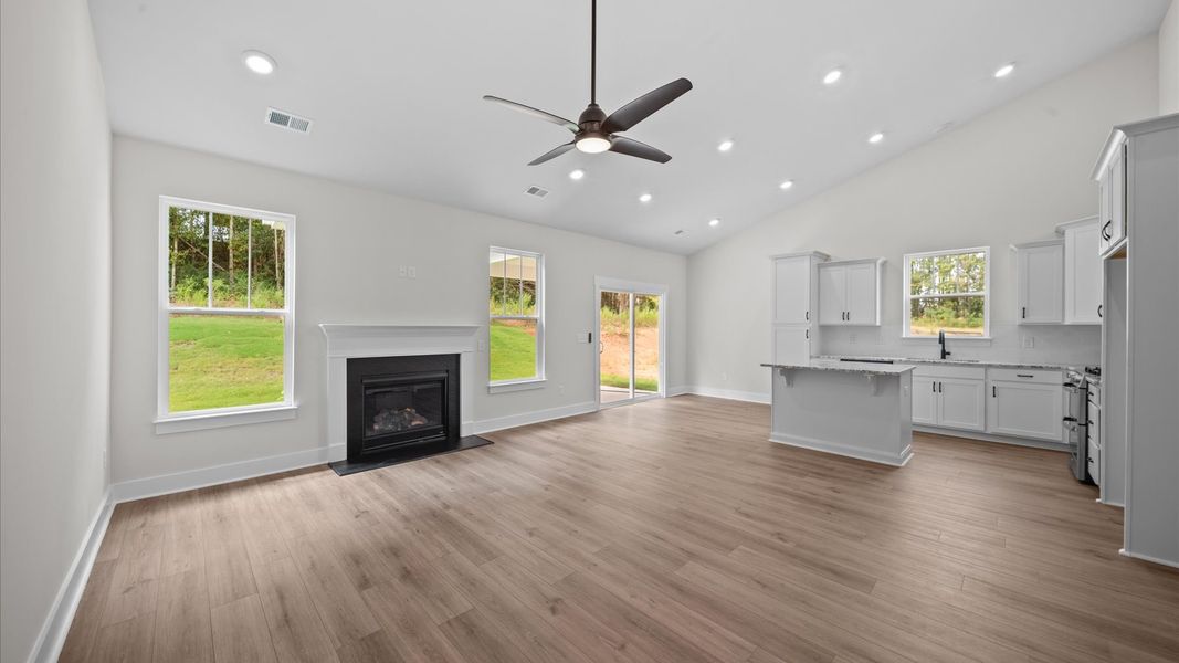 Eye-catching two-story family room with elegant trim, oversized windows, and elevated design