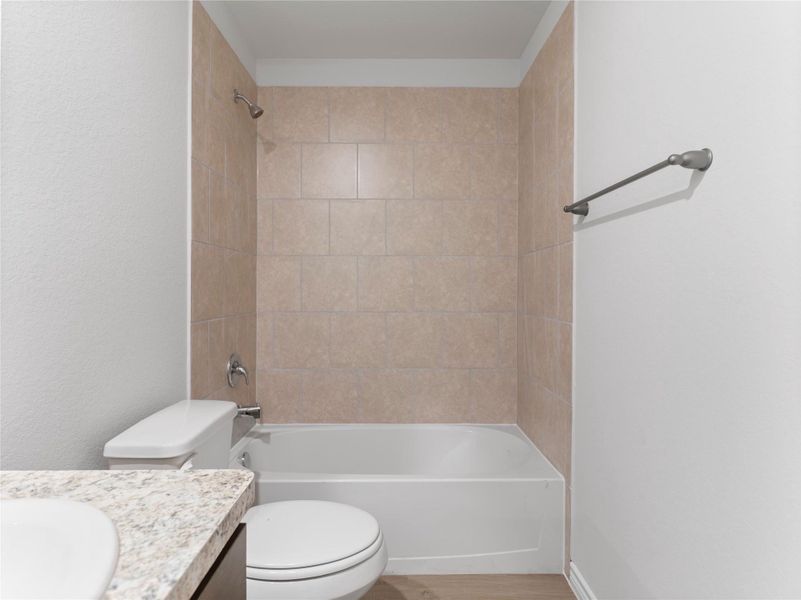 Upstairs full bath with a sleek tub and shower combo.