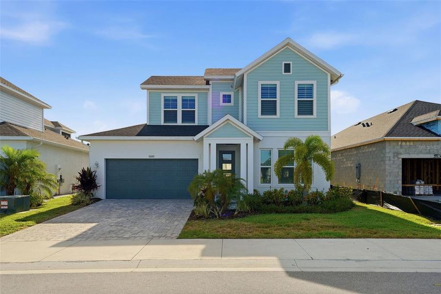 Front exterior of a new home in Emerald Landing at Waterside at Lakewood Ranch – Lake Series, Sarasota, FL, highlighting curb appeal (Image 1). Front exterior of a new home in Emerald Landing at Waterside at Lakewood Ranch – Lake Series, Sarasota, FL, highlighting curb appeal (Image 1).