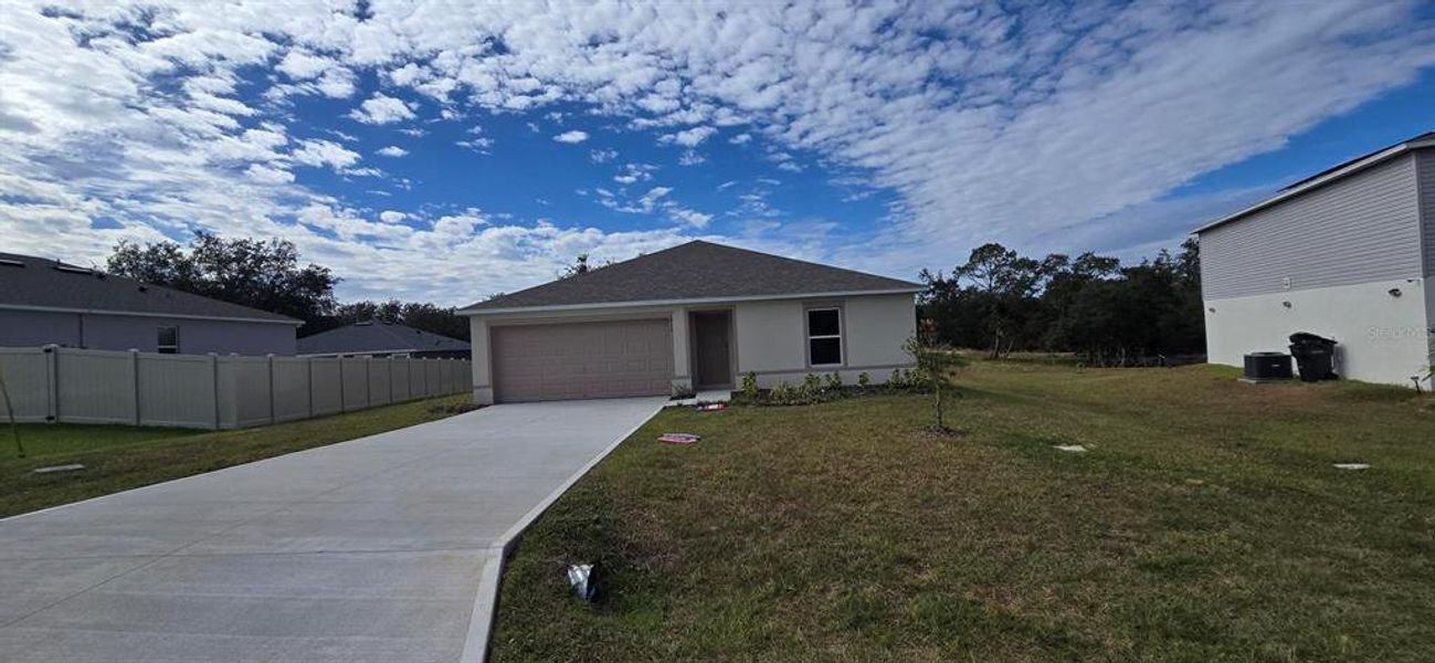 Front exterior of a new home in Poinciana, Poinciana, FL, highlighting curb appeal (Image 1).