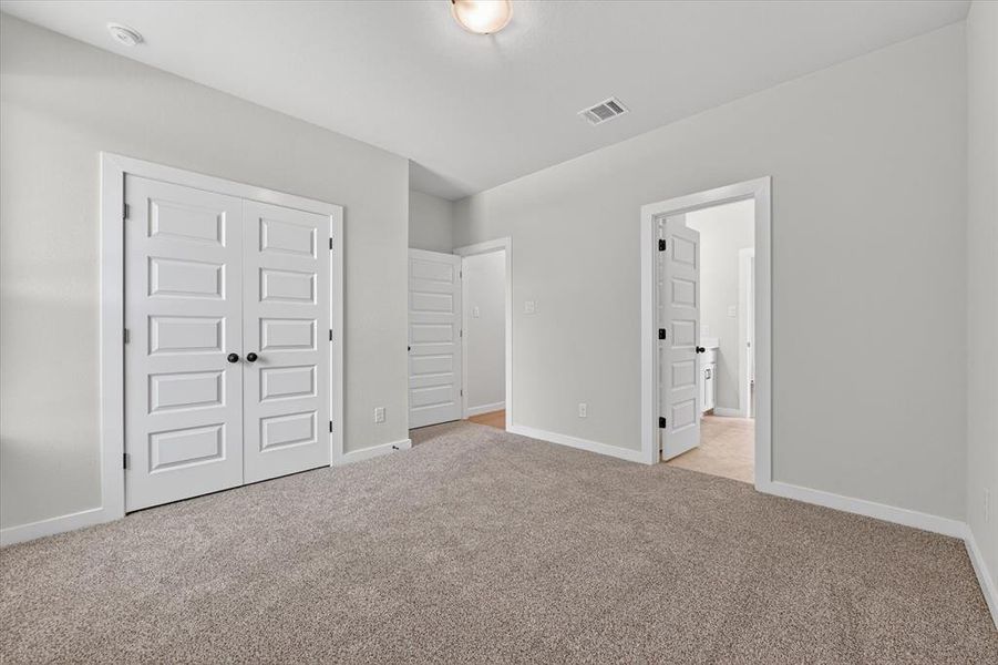 Light gray wall paint complemented by white trim and a neutral carpet