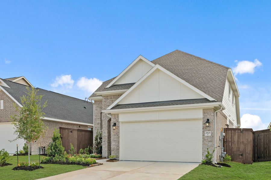 Front exterior of a new home in The Trails, New Caney, TX, highlighting curb appeal (Image 1).