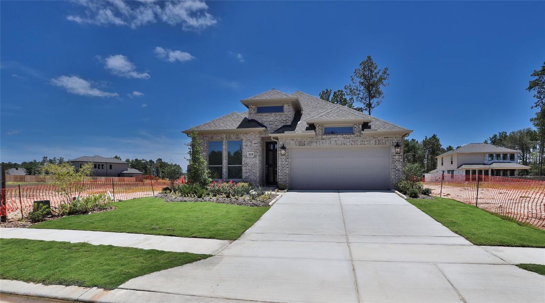 Front exterior of a new home in Artavia 45', Conroe, TX, highlighting curb appeal (Image 1). Front exterior of a new home in Artavia 45', Conroe, TX, highlighting curb appeal (Image 1).