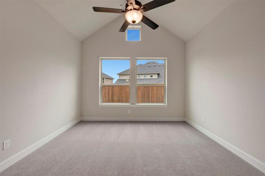 Unfurnished room featuring light carpet and a ceiling fan