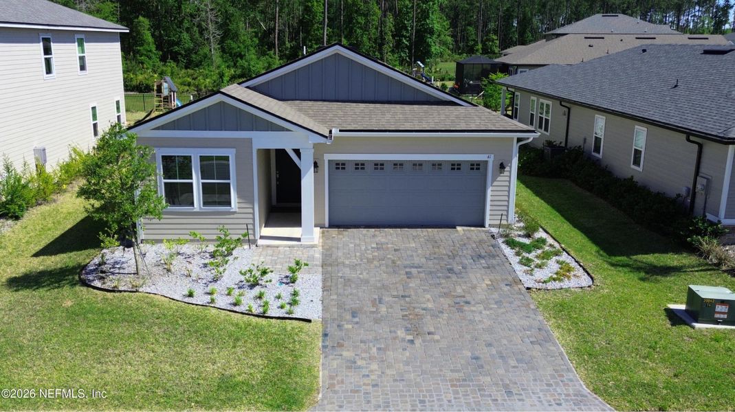 Front exterior of a new home in Seasons at TrailMark, St. Augustine, FL, highlighting curb appeal (Image 33).