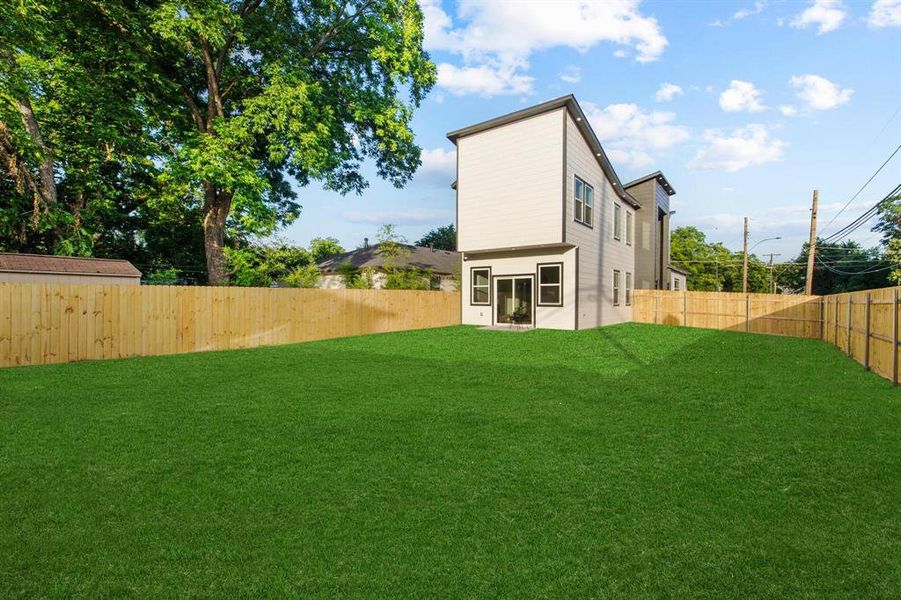 Back of property with a fenced backyard