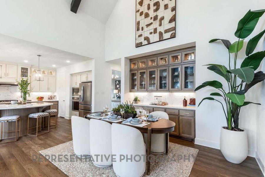Dining area with dark wood-type flooring, high vaulted ceiling, recessed lighting, and a chandelier Dining area with dark wood-type flooring, high vaulted ceiling, recessed lighting, and a chandelier