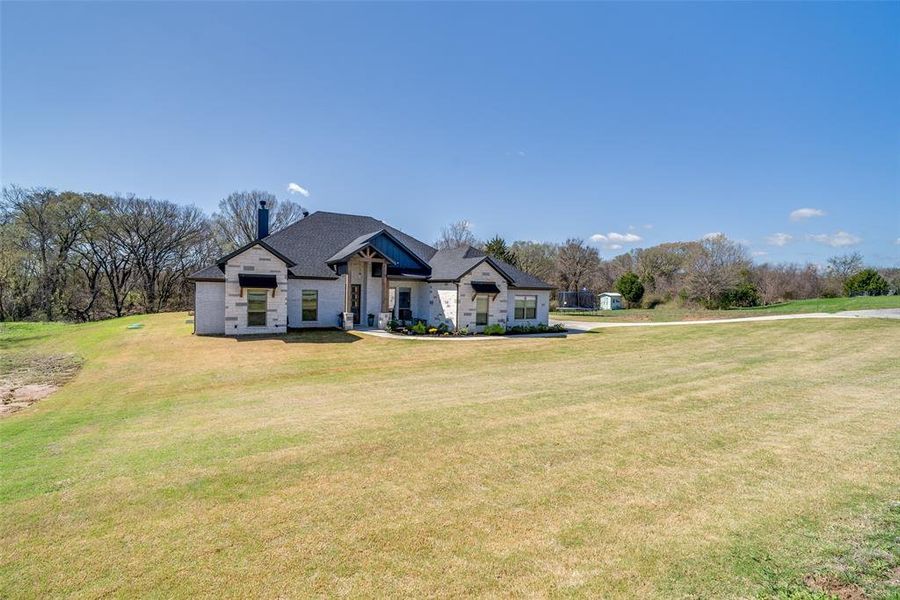 Front exterior of a new home in Kessler Farms, Brock, TX, highlighting curb appeal (Image 20). Front exterior of a new home in Kessler Farms, Brock, TX, highlighting curb appeal (Image 20).