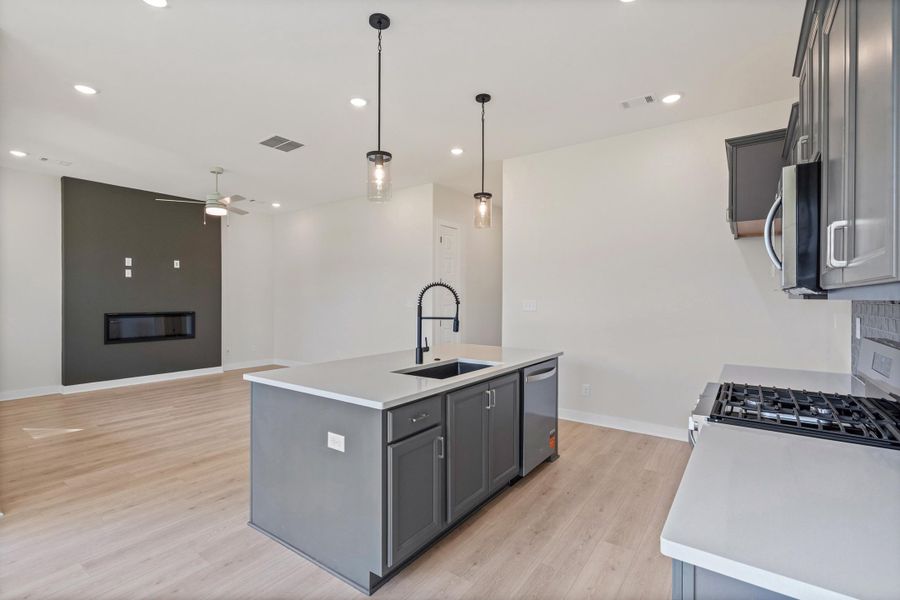 Open concept living space featuring wood-finish flooring