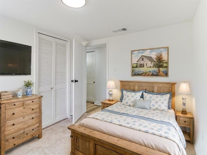 Bedroom with light colored carpet and a closet Bedroom with light colored carpet and a closet