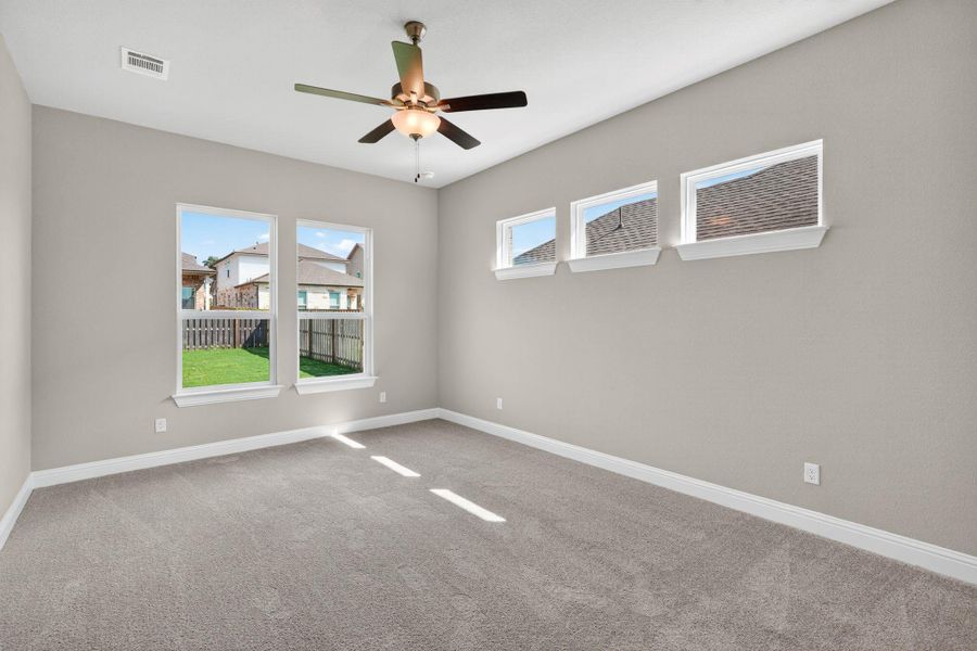 Carpeted empty room featuring baseboards and a ceiling fan Carpeted empty room featuring baseboards and a ceiling fan