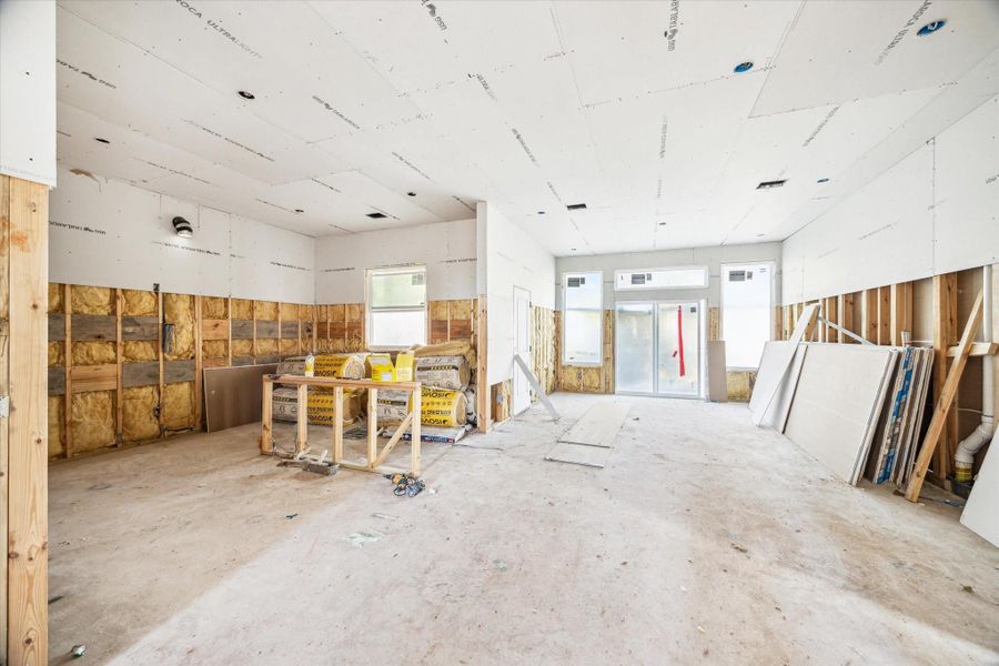 View from the Foyer looking back towards the Dining/Family room. The open kitchen has a center Island and Extensive Cabinetry